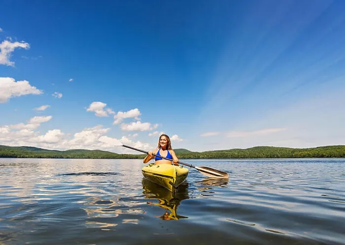 Framed Print : Young woman kayaking on lake Framed Print : Young woman kayaking on lake