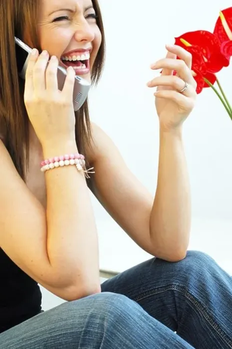 Framed Print : Young woman on mobile telephone smiling Framed Print : Young woman on mobile telephone smiling