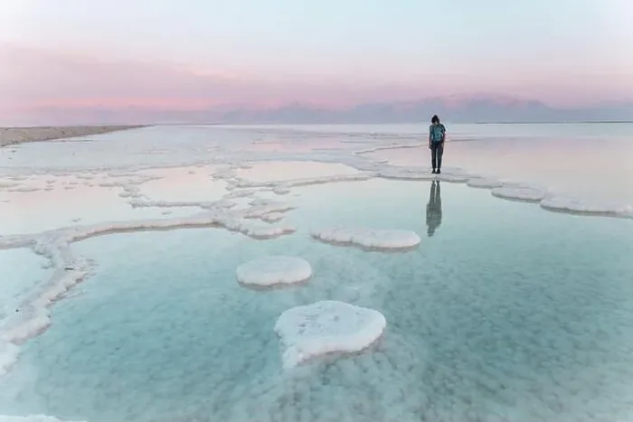 Framed Print : Young woman standing on salt formations in dead sea at sunset Framed Print : Young woman standing on salt formations in dead sea at sunset