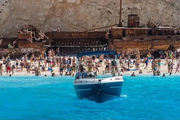 Framed Print : Zakynthos, Greece - August 20, 2019: speed boat leaves shipwreck navagio beach in summer Framed Print : Zakynthos, Greece - August 20, 2019: speed boat leaves shipwreck navagio beach in summer