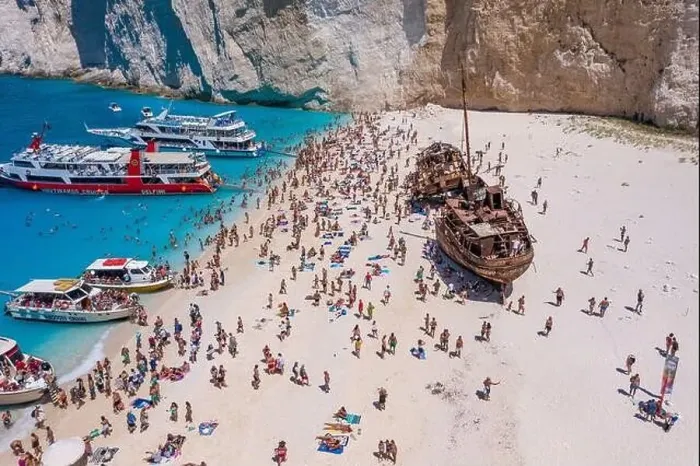 Framed Print : Zakynthos, Greece - August 20, 2019: Tourists enjoy summer time by abandoned rusty ship on shipwreck navagio beach Framed Print : Zakynthos, Greece - August 20, 2019: Tourists enjoy summer time by abandoned rusty ship on shipwreck navagio beach