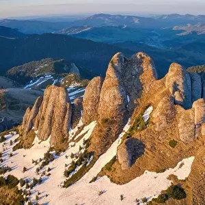 Aerial view over Ciucas Mountains, Tigaile Mari peak, Romania, Europe. Morning light at sunrise