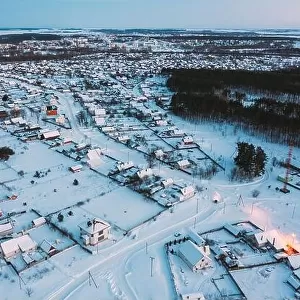 Aerial View Of Town Skyline Winter Evening Night. Snowy Landscape Cityscape Skyline