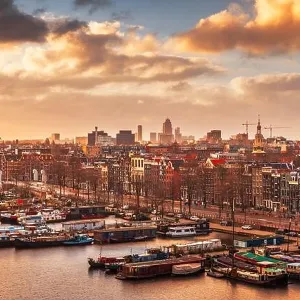 Amsterdam, Netherlands city skyline on the North Sea Canal at dusk Amsterdam, Netherlands city skyline on the North Sea Canal at dusk