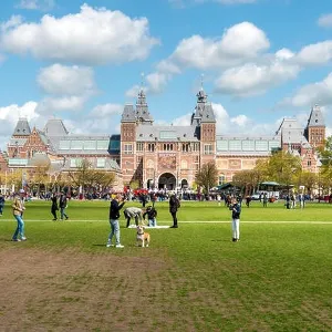 Amsterdam, Netherlands on May 03, 2016 : People chilling in the park on The Museumplein near Rijksmuseum museum area in Amsterdam, Netherlands