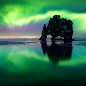 Aurora borealis (Northern lights) over Basalt stack Hvitserkur on the Vatnsnes peninsula, Iceland. Landscape photography. Courtesy of NASA