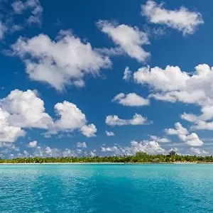 Beautiful Maldivian atoll with white beach seen from the sea. Tropical lagoon and island paradise