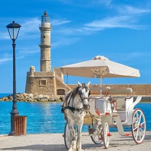 Carriage with horse on the Venetian Harbour, lighthouse in the background, Chania, Crete Island, Greece Carriage with horse on the Venetian Harbour, lighthouse in the background, Chania, Crete Island, Greece