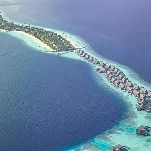 Fantastic aerial landscape, luxury tropical resort or hotel with water villas and beautiful beach scenic. Amazing bird eyes view in Maldives landscape