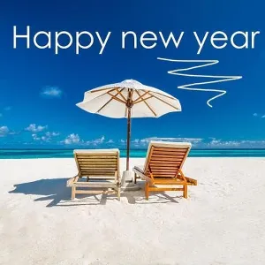 Happy new year written in the sky. Artistic summer beach holiday with new years eve concept Happy new year written in the sky. Artistic summer beach holiday with new years eve concept