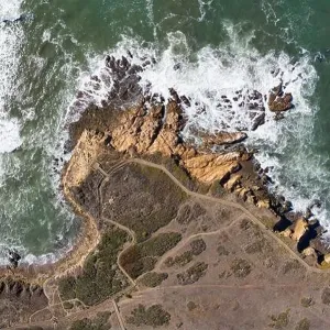 The Pacific Ocean washes against the rocky seashore of Central California in Morro Bay. This beautiful coastal region is known for its scenic coast The Pacific Ocean washes against the rocky seashore of Central California in Morro Bay. This beautiful coastal region is known for its scenic coast