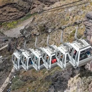 Santorini cable car, transporting tourist above the cliffs to Fira port. Summer vacation Santorini cable car, transporting tourist above the cliffs to Fira port. Summer vacation