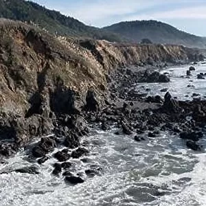 The serene Pacific Ocean washes onto the rugged coastline of Northern California. The Pacific Coast Highway runs right along this region in Mendocino