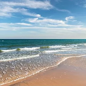 Tide waves on tropical beach sand and blue ocean water. Beauty sea texture. Vacations background