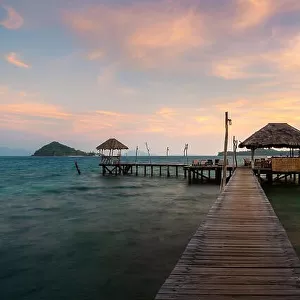 Wooden bar in sea and hut with dramatic sunset sky in Koh Mak at Trat, Thailand. Summer, Travel, Vacation and Holiday concept