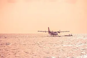 05.06.2019 - Ari Atoll, Maldives: Exotic scene with seaplane on Maldives sea landing. Vacation holiday in Maldives concept background. Seaplane taxi