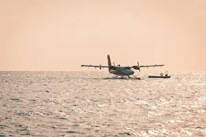 05.06.2019 - Ari Atoll, Maldives: Exotic scene with seaplane on Maldives sea landing. Vacation holiday in Maldives concept background. Seaplane taxi