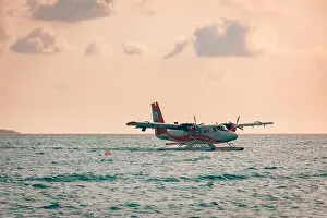 05.06.2019 - Ari Atoll, Maldives: Exotic scene with seaplane on Maldives sea landing. Vacation holiday in Maldives concept background. Seaplane taxi