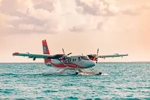 05.06.2019 - Ari Atoll, Maldives: Exotic scene with seaplane on Maldives sea landing. Vacation holiday in Maldives concept background. Seaplane taxi