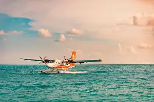 05.06.2019 - Ari Atoll, Maldives: Exotic scene with seaplane on Maldives sea landing. Vacation holiday in Maldives concept background. Seaplane taxi