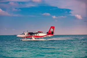 05.06.2019 - Ari Atoll, Maldives: Exotic scene with seaplane on Maldives sea landing. Vacation holiday in Maldives concept background. Seaplane taxi
