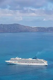 10.05.19. - Santorini, Greece: Norwegian Jade cruise ship in Santorini sea bay, Blue water with volcanic cliffs over the horizon. Luxury cruiser Fira