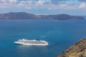 10.05.19. - Santorini, Greece: Norwegian Jade cruise ship in Santorini sea bay, Blue water with volcanic cliffs over the horizon. Luxury cruiser Fira