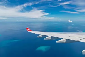 10.12.2016 - Maldives, Male: Turkish Airlines Being 777 landing in Maldives capital city and airport, blue sea and island view from plane