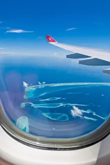 10.12.2016 - Maldives, Male: Turkish Airlines Being 777 landing in Maldives capital city and airport, blue sea and island view from plane