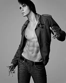 Biker Prints: 18 years old caucasian model with six pack abs posing with attitude wearing biker jacket