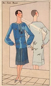 1920s woman in blue crepe dress embroidered with silver birds, pleated skirt, stading in front of a mirror