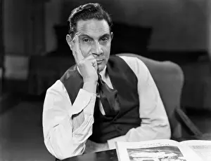Worry Prints: 1930s 1940s MAN SEATED ELBOWS ON TABLE FACE LEANING ON HAND SERIOUS EXPRESSION WEARING SHIRT TIE VEST LOOKING AT CAMERA