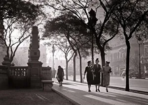 1930s 1940s SUNSET CREATES MOODY ATMOSPHERE FOR THREE WOMEN WALKING TOGETHER ALONG PLAZA CONGRESS BUENOS AIRES ARGENTINA - r12624 PAL001 HARS ALONG