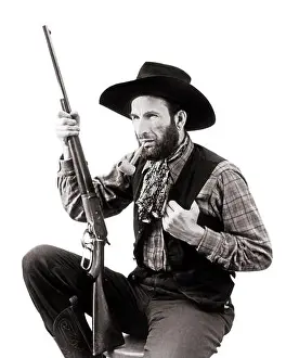 Old Fashion Prints: 1930s CHARACTER MAN WESTERN COWBOY WEARING HAT VEST NECKERCHIEF SMOKING PIPE HOLDING LEVER ACTION RIFLE - c747 HAR001