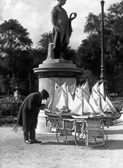 Occupations Prints: 1930s PARIS FRANCE TUILERIES GARDENS MAN WITH CART OF MINIATURE TOY SAILBOATS FOR RENT