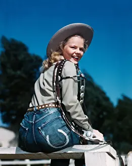 Hars Prints: 1940s 1950s SMILING BLOND WOMAN WEARING WESTERN COWGIRL CLOTHES LOOKING OVER SHOULDER SITTING ON WOODEN FENCE