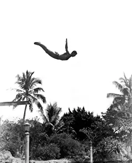20 25 Prints: 1940s MAN POISED MIDAIR ARMS OUT JUMPING FROM DIVING BOARD INTO POOL