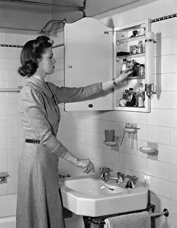 Old Fashioned Prints: 1940s WOMAN REACHING INTO BATHROOM MEDICINE CABINET