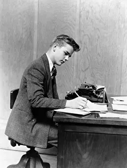 Hars Prints: 1940s YOUNG MAN SITTING AT DESK WRITING MANUAL TYPEWRITER STUDY COLLEGE OFFICE BUSINESSMAN OR STUDENT