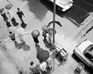 Hars Prints: 1950s AERIAL OF STREET CORNER IN THE RAIN PEDESTRIANS WITH UMBRELLAS CARS WET PAVEMENT PARK AVE & 48TH STREET NEW YORK