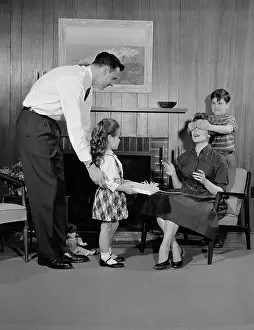 Grown Up Prints: 1950s FAMILY LIVING ROOM WOMAN MOTHER GETTING SURPRISE GIFT FROM CHILDREN DAUGHTER SON HUSBAND