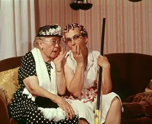 Secrets Prints: 1960s TWO SENIOR OLDER WOMEN SITTING ON SOFA GOSSIPING
