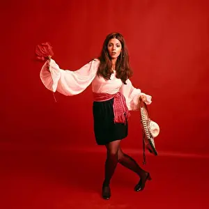 1970s BRUNETTE WOMAN WEARING MEXICAN LATIN HISPANIC SPANISH CHARACTER COSTUME RED BACKDROP