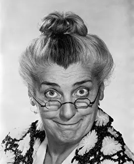 Healthiness Prints: 1970s PORTRAIT ELDERLY WOMAN WITH HAIR IN BUN WEARING GRANNY GLASSES SMILING LOOKING AT CAMERA
