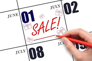 Friday Prints: 1st day of July. Hand writing text SALE and drawing gift boxes on calendar date July 1