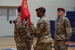 1st Sgt. Travis Stoddard, outgoing Headquarters Battery 1st Sgt. passes guide-on as to signify the change of responsibility at Tower Barracks