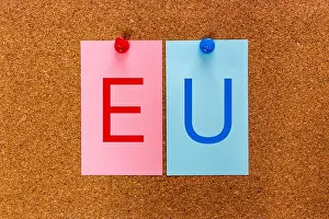 Stickers Prints: 2 letters keyword EU (The European Union) on stickers attached to a cork board