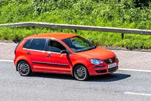 Freeway Prints: 2009 red Volkswagen Polo E 60; Vehicular traffic moving vehicles
