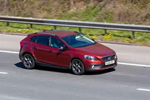 2016 red Volvo V40 D2 Cross Country Lux 1969cc diesel 6 speed automatic driving on the M61 Motorway, Manchester, UK
