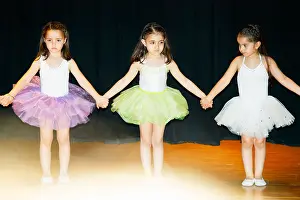 Ballerina Prints: 3 (Three) dressed little ballerina girls / children (4 5 years old) performing ballet on the stage